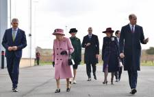 Britain's Queen Elizabeth II (C) and Britain's Prince William, Duke of Cambridge (R) arrive with Dstl Chief Executive Gary Aitkenhead (L) at the Energetics Analysis Centre as they visit the Defence Science and Technology Laboratory (Dstl) at Porton Down science park near Salisbury, southern England, on October 15, 2020. Picture: AFP