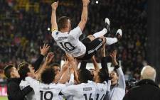 Teammates throw Germany's midfielder Lukas Podolski in the air after the friendly football match of Germany vs England in Dortmund, western Germany, on 22 March, 2017. It was Lukas Podolski’s last match with the German team. Picture: AFP.