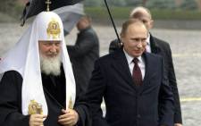 Russian President Vladimir Putin (right) walks with Russian Orthodox Church Patriarch Kirill, left, at the Red Square on 4 November, 2013. Picture: AFP.
