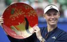 Caroline Wozniacki holds the winning plate after winning the final match against Anastasia Pavlyuchenkova at Pan Pacific Open Women’s tennis tournament in Tokyo. Picture: @SI_Tennis/Twitter.