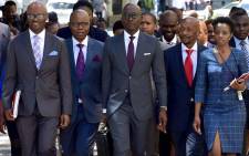 Finance Minister Malusi Gigaba (center) arrives at Parliament flanked by Deputy Minister Buthelezi (second left), SARS Commissioner Moyane (right) and Treasury Director-General Dondo Mogajane (left). Picture: GCIS