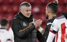 Manchester United manager Ole Gunnar Solskjaer (L) congratulates defender Alex Telles after the English Premier League football match between Sheffield United and Manchester United at Bramall Lane in Sheffield, northern England on 17 December 2020. Picture: AFP