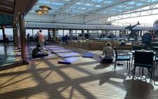 This photo taken and obtained from the Twitter account of Christina Kerby (@ChristinaKerby) on 12 February 2020 shows passengers on yoga mats onboard the US cruise ship Westerdam in the Gulf of Thailand. Picture: AFP