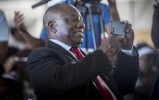 Deputy President Cyril Ramaphosa takes a video on his cellphone during a World Aids Day event in Daveyton, east of Johannesburg on 1 December 2016. Picture: Reinart Toerien/EWN