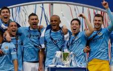 Manchester City players celebrate with the League Cup during the presentation after Manchester City won the League Cup final against Sunderland at Wembley Stadium in London on 2 March 2014. Picture: AFP.