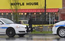 Law enforcement stand outside a Waffle House where four people were killed and two were wounded after a gunman opened fire with an assault weapon on 22 April, 2018 in Nashville, Tennessee. Picture: AFP