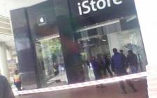 Police cordon off the scene of the iStore robbery at Centution Mall on 22 August 2014. Picture: Twitter via @kelstamza.