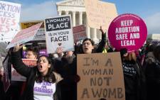 FILE: Pro-choice activists hold signs in response to anti-abortion activists participating in the "March for Life," an annual event to mark the anniversary of the 1973 Supreme Court case Roe v. Wade, which legalised abortion in the US, outside the US Supreme Court in Washington, DC, 18 January 2019. Picture: AFP