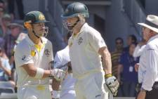 Australian batsman David Warner (L) is congratulated by fellow opening batsman Chris Rogers (C). Picture: AFP.