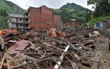 Rescuers look for survivors in the rubble of damaged buildings after a landslide caused by torrential rain from Typhoon Lekima, at Yongjia, in Wenzhou, in China's eastern Zhejiang province on 10 August 2019. Picture: AFP