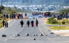 Protesters in Grabouw in the Western Cape block the road during a demonstration over the lack of housing, poor and expensive electricity supply and bad road conditions on Tuesday, 16 September 2014. Picture: Sapa.