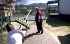 Screenshot from a viral cell phone video shows a grade 8 Glenvista High School student attacking his teacher with a broom on 18 September 2013. It was sent to EWN by a concerned parent and was filmed by another student.