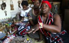 Agnes Gaobepe, 36, a sangoma working in Wattville, a township of Benoni, gestures on 09 September 2004. "Under apartheid, we were referred to as witch doctors, which is something that is opposite to what we do. We are traditional herbal healers, we concentrate on curing" she says. Picture: AFP.