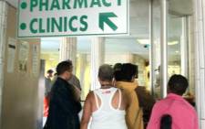 Patients queuing outside a hospital pharmacy 