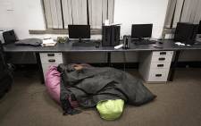 A Wits student sleeps in the postgraduate lab. He is one of 19 students waiting for the Department of Arts and Culture to pay the funds of their promised bursaries. Picture: Sethembiso Zulu/EWN