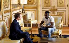 French President Emmanuel Macron speaks with Mamoudou Gassama, 22, from Mali, at the presidential Elysee Palace in Paris, on 28 May 2018. Picture: AFP