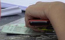 FILE: A resident checks her name at a voting station. Picture: EWN
