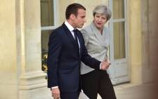 FILE: Britain's Prime Minister Theresa May and France’s President Emmanuel Macron following a meeting to give a joint press conference in the grounds of The Elysee Palace in Paris on 13 June 2017. Picture: AFP.