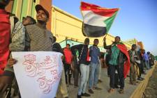Sudanese protesters wait at a train station in Khartoum to board a train to Atbara on 19 December 2019 to celebrate the one-year anniversary of their protest movement that brought down Omar al-Bashir last April after a thirty-year rule. Picture: AFP