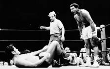US boxer Muhammad Ali, born Cassius Marcellus Clay Jr. on 17 January, 1942, three-time World Heavyweight Champion and winner of an Olympic Light-heavyweight gold medal, shouts at a Japanese fighter during an exhibition fight in Tokyo, 1 July 1976. Picture: AFP.