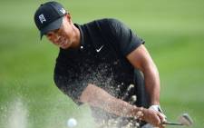 Tiger Woods plays a bunker shot. Picture: AFP