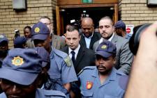 FILE: Oscar Pistorius leaves Pretoria High Court under heavy security after the second day of his murder trial on 4 March 2014. Picture: EWN.