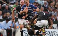 Western Province flank Schalk Burger(C) breaks through a tackle during the Absa Currie Cup Final match between the Sharks and Vodacom Western Province.Picture: AFP/STRINGER