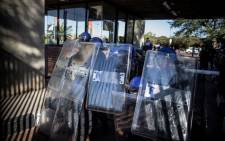 Private security agents working for the University of Johannesburg take position as they shut the gates of the campus during clashes with rioting students, on September 28, 2016. Picture: AFP