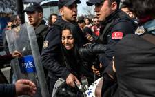 Turkish anti-riot police officers detain a woman on 6 March, 2016, during a march in Kadikoy district in Istanbul to mark International Women’s Day. Picture: AFP.