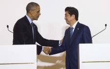FILE: US President Barack Obama(L) shakes hands with Japanese Prime Minister Shinzo Abe during the Group of Seven (G7) summit meetings in Shima on May 25, 2016. Picture: AFP.