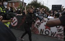 A protestor calls for the crowd to "Say Her Name Breonna Taylor" while marching in downtown Louisville, Kentucky, on 23 September 2020, after a judge announced the charges brought by a grand jury against Detective Brett Hankison, one of three police officers involved in the fatal shooting of Breonna Taylor in March. Picture: AFP