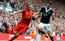 FILE: Southampton's English midfielder Adam Lallana (R) competes with Liverpool's Brazilian midfielder Lucas Leiva (L) during the English Premier League football match between Liverpool and Southampton on September 21, 2013. Picture: AFP