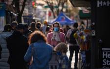 People queue to be tested for COVID-19 at a street-side testing booth in New York on 17 December 2021. Picture: AFP