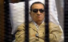 Egyptian president Hosni Mubarak sits inside a cage in a courtroom during his verdict hearing in Cairo on 2 June 2012. Picture: AFP.