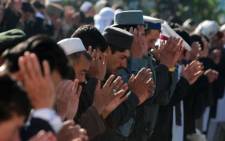 FILE: Afghan devotees pray during Eid al-Adha at the Shah-e Do Shamshira mosque in Kabul on 26 October 2012. The festival of sacrifice is celebrated throughout the Muslim world as a commemoration of Abraham's willingness to sacrifice his son for God, with cows, camels, goats and sheep are traditionally slaughtered on the holiest day. Munir uz Zaman/AFP