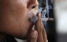 A man smokes a cigarette. Picture: AFP