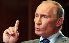 FILE:Russian Prime Minister Vladimir Putin gestures while speaking during an interview with major French media outlets Agence France-Presse (AFP) and France 2 television in Sochi on 7 June 2010. Picture: AFP. 