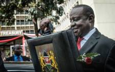 Kenya's Cabinet Secretary for National Treasury Henry Rotich leaves with the budget briefcase for Parliament to read the budget speech for 2018-2019 in Nairobi, Kenya, on 14 June 2018. Picture: AFP