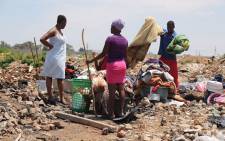 Community members in Alexandra gather their belongings after floods in the area on 10 November 2016. Picture: Christa Eybers/EWN.

