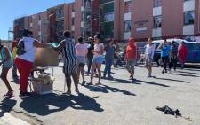 Clarkes Estate residents in Elsies River, Cape Town receive their meals from community activists on 22 April 2020. Picture: Kaylynn Palm/Eyewitness News.