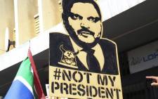 FILE: Many anti-Zuma protesters carried placards addressing the former president's alleged ties to the Gupta family during protests against corruption. Picture: EWN