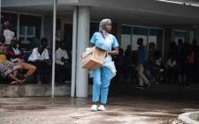 A nurse carries supplies at the Central Hospital of Beira after Cyclone Idai swept through the city. Picture: Christa Eybers/EWN.