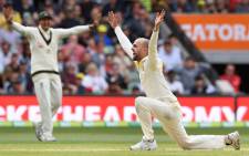 FILE: Australia's spinner Nathan Lyon (R) appeals successfully for an LBW decision against England's batsman Alastair Cook on the fourth day of the second Ashes cricket Test match in Adelaide in December 5, 2017. Picture: AFP