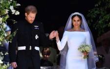 FILE: Britain's Prince Harry, Duke of Sussex and his wife Meghan, Duchess of Sussex emerge from the West Door of St George's Chapel, Windsor Castle, in Windsor, on 19 May 2018 after their wedding ceremony. Picture: AFP.