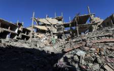 FILE. A general view shows destruction in a residential neighbourhood in the adjacent modern town to the ancient Syrian city of Palmyra on 31 March 2016. Picture: AFP.