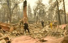 Alameda County Sheriff Coroner officers search for human remains at a burned residence in Paradise, California on 12 November, 2018. Picture: AFP