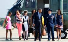 US President Barack Obama and his wife Michelle and children Sasha and Malia with their cousin Leslie Robinson get ready to depart on their African tour. Picture: AFP