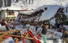 Local residents remove debris of a collapsed house following heavy snowfall that triggered an avalanche in Neelum Valley, in Pakistan-administered Kashmir on 14 January 2020. Picture: AFP