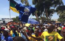 Demonstrators are in full voice singing old liberation struggle songs as they wait for more people to arrive. Picture: Vumani Mkhize/EWN.