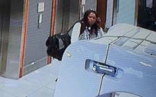 A video screengrab of security footage showing a woman leaving the Zondo commission of inquiry into state capture after stealing equipment belonging to the SABC on 26 November 2018.